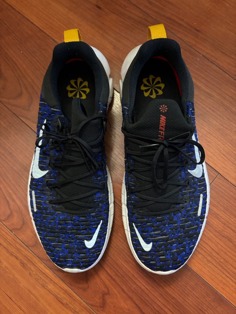 Nike Men's Flyknit Sneakers in Black, Blue & White with Yellow Heel Tab